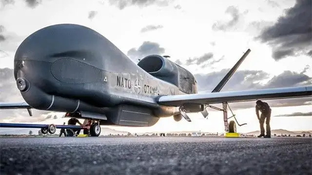 NATO AGS RQ-4D Phoenix aircraft with ground crew on an airfield